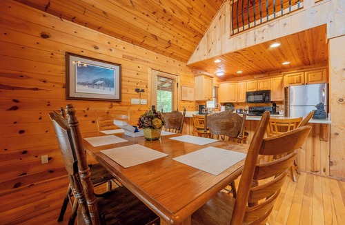 Draper House | Sunny riverside cabin with loft views, big deck, game room, porches, and open lawn.
