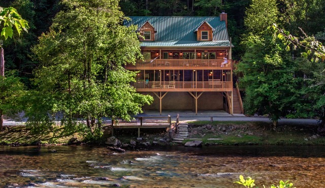 Log cabin with large decks on the Bank of the Tuckasegee River. in Webster